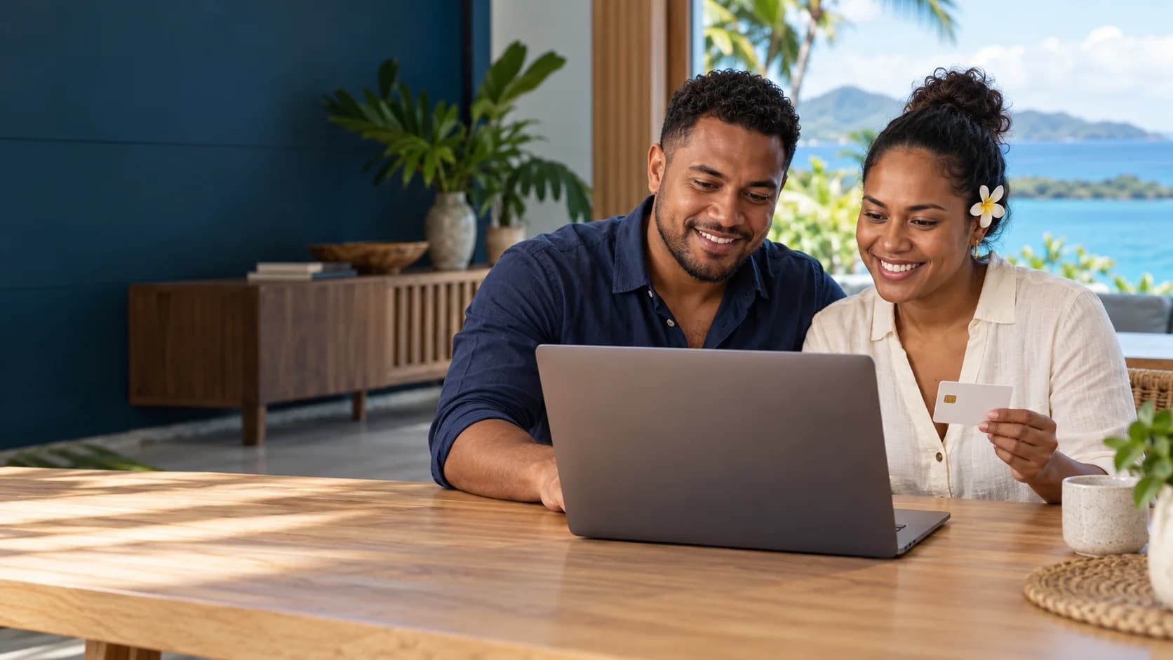 Illustrative couple using a laptop together, with one partner holding a credit card